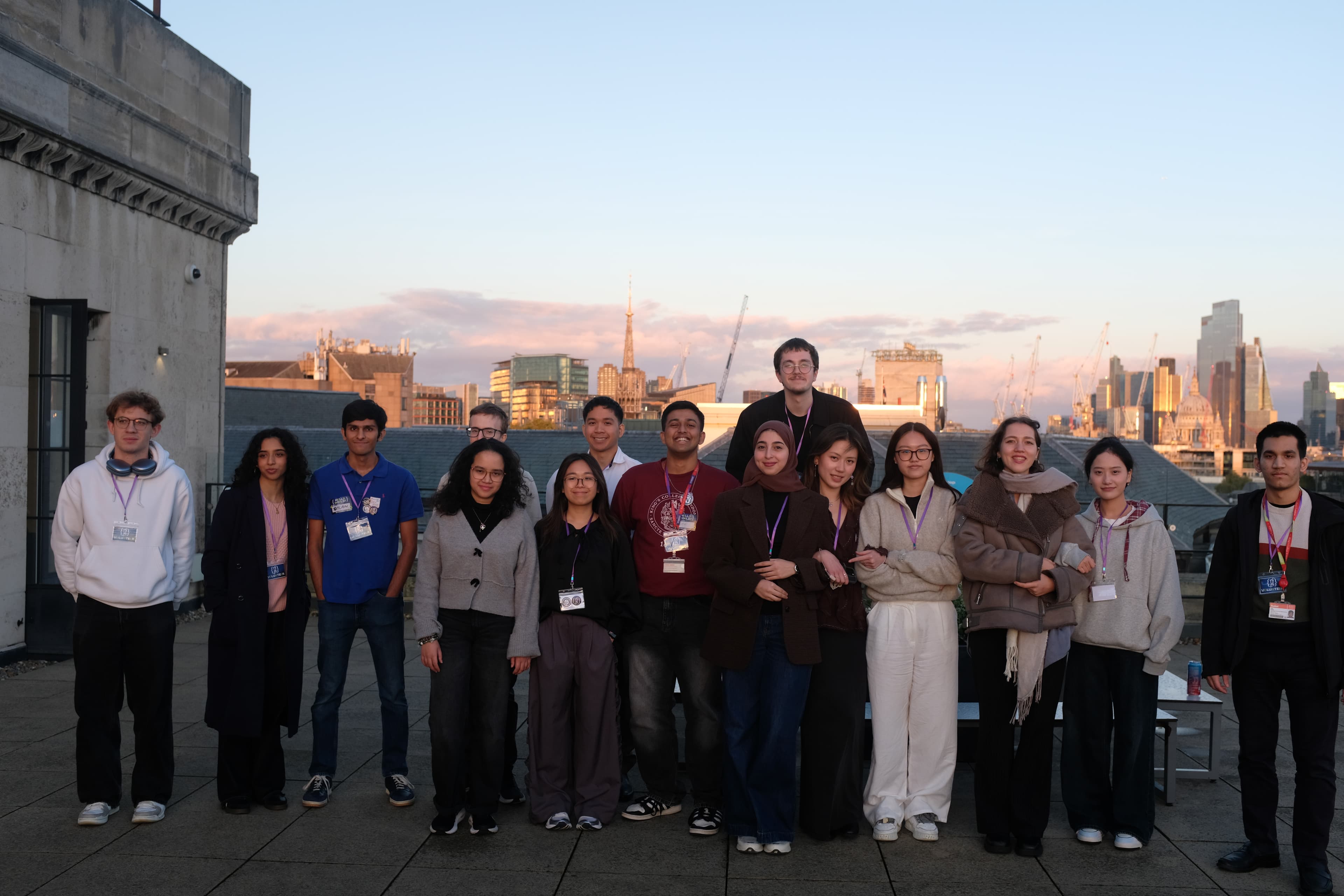 KCL Tech students standing together on a rooftop with the London skyline behind them