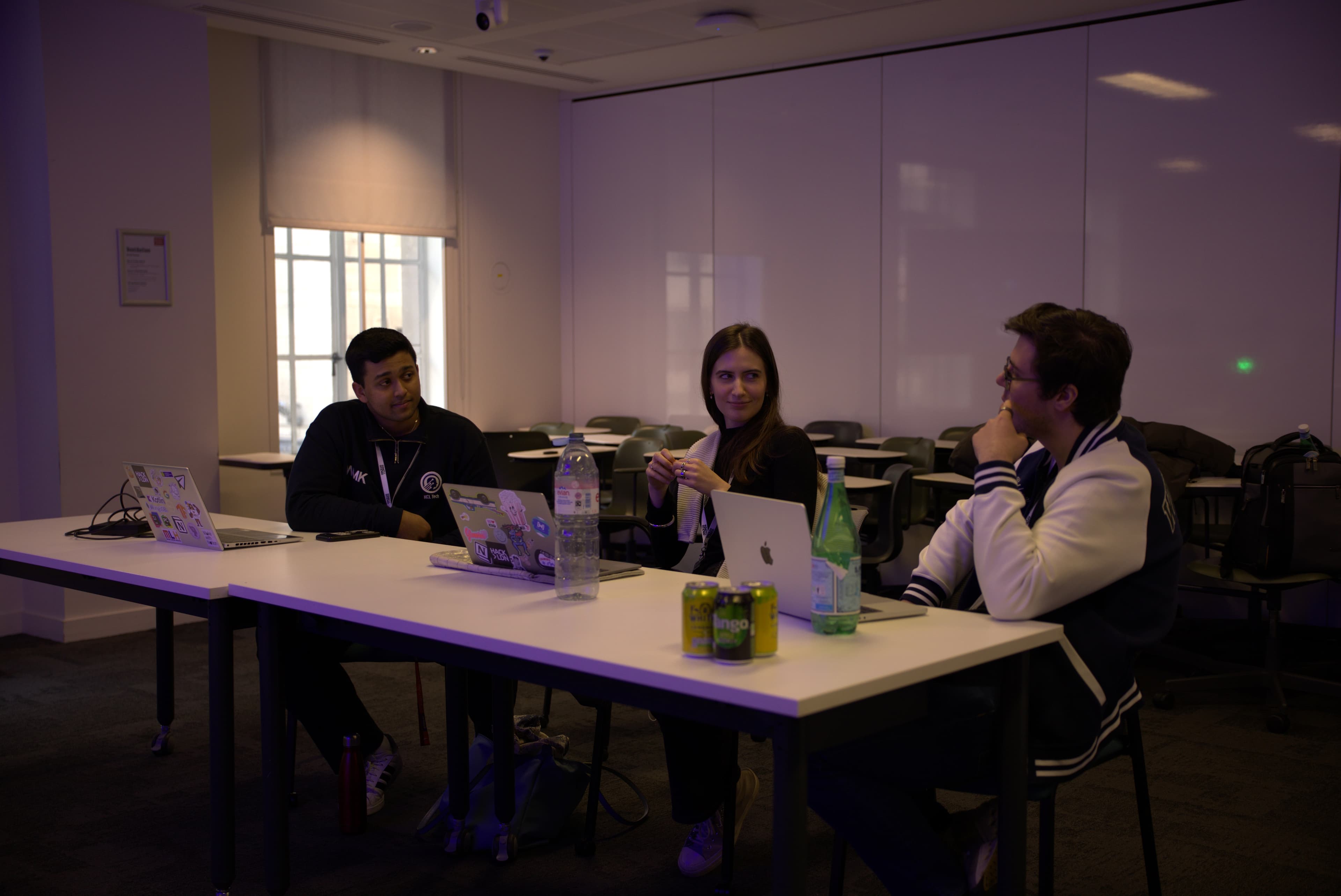 Judges at HackLondon reviewing student projects